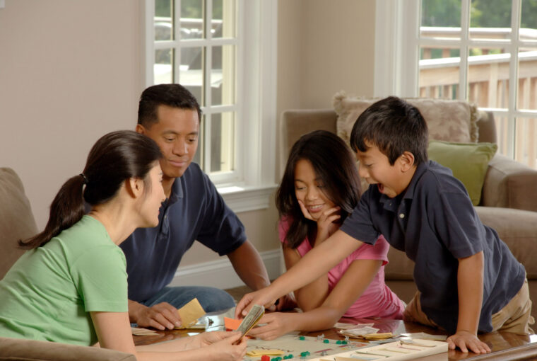 family playing board game